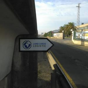Rótulo Cartel flecha rotulado con vinilo, para Land Cargo en Sevilla.