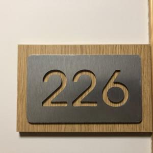 Rótulo en acero recortado y con base o metopa de madera.