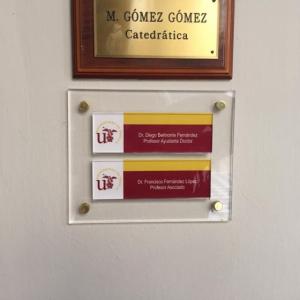 Rótulo Cartel de señalización en base de metaxcrialto con carpetas resposicionable. Facultad de Geografía e Historia de la Universidad de Sevilla.