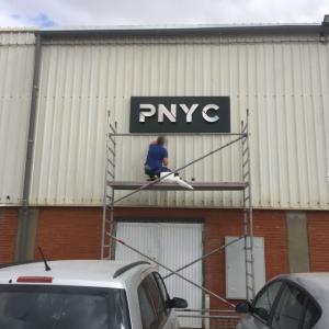 Rótulo corpóreo en acero inoxidable sobre bandeja de composite para PNYC en Sevilla.